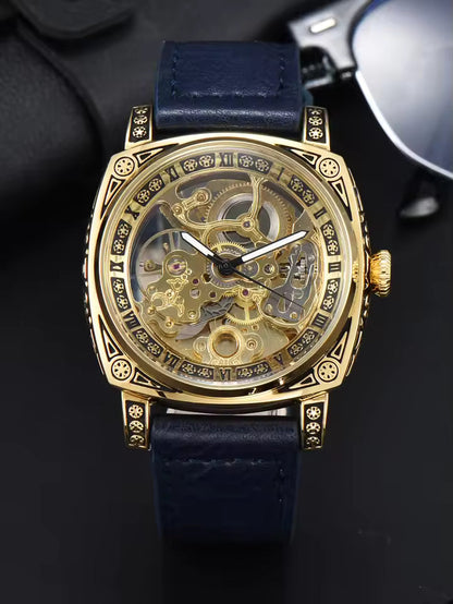 Gold Blue — gold-tone automatic skeleton watch with navy leather strap